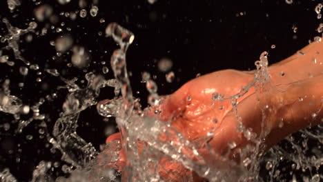 water pouring over female hands