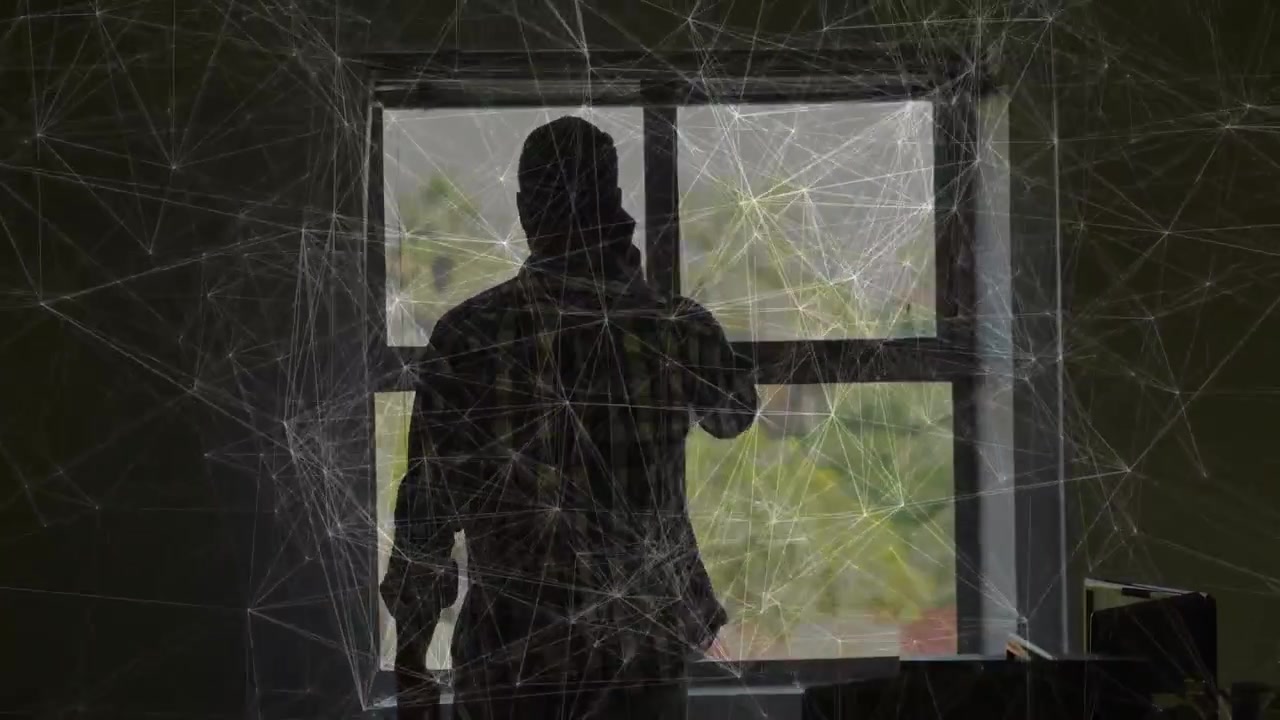 Man at window answering call, raising hand holding phone while web overlay framing gesture for tech