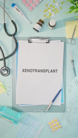 vertical video of xenotransplant written on medical paper
