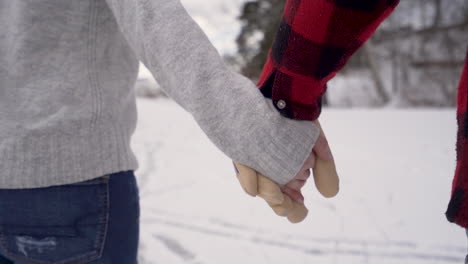 close up of hands of couple ice skating in slow motion