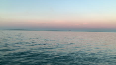 beautiful sunset over the sea, calm waves on the sea, orange sky on the horizon, dreamy end of the day