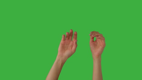 woman waving hands over green background