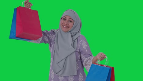 happy muslim woman doing shopping green screen
