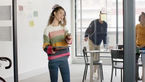 Busy-diverse-business-people-discussing-work-at-meeting-with-glass-wall-in-office-in-slow-motion