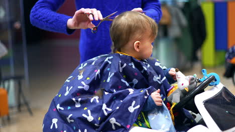 baby getting a haircut at a child-friendly salon