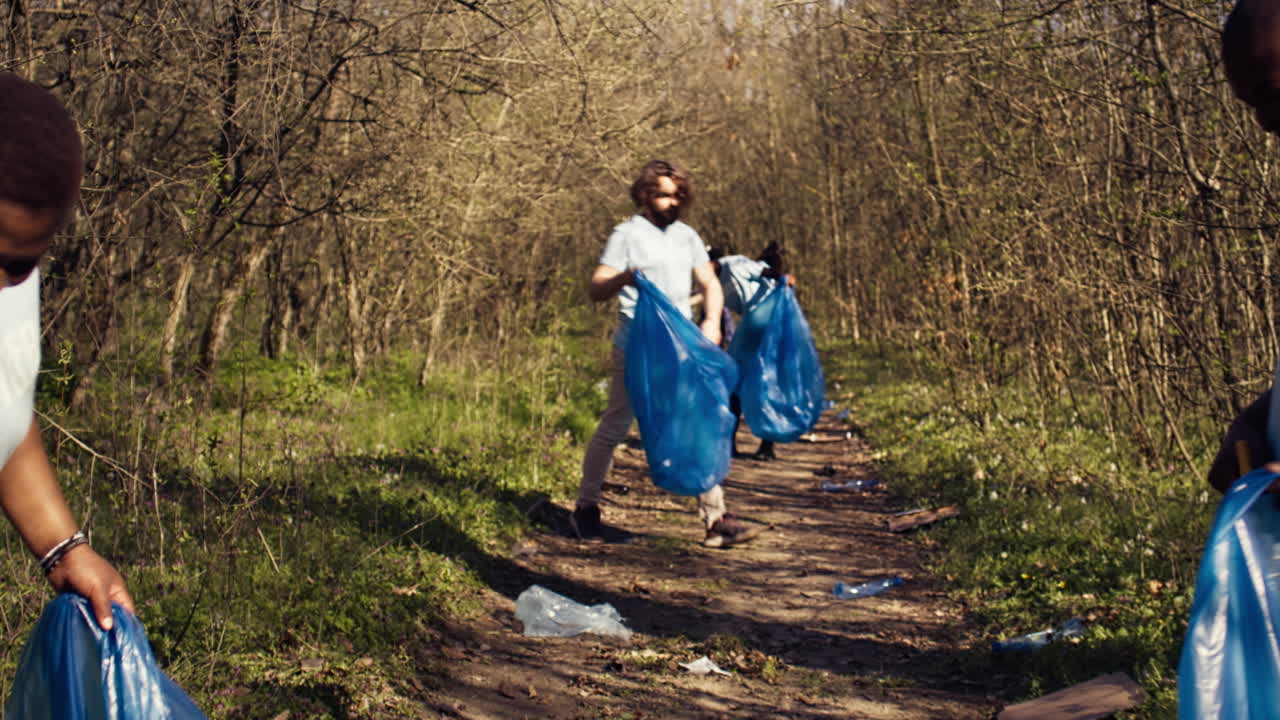 Group of diverse activists picking up the trash and plastic waste