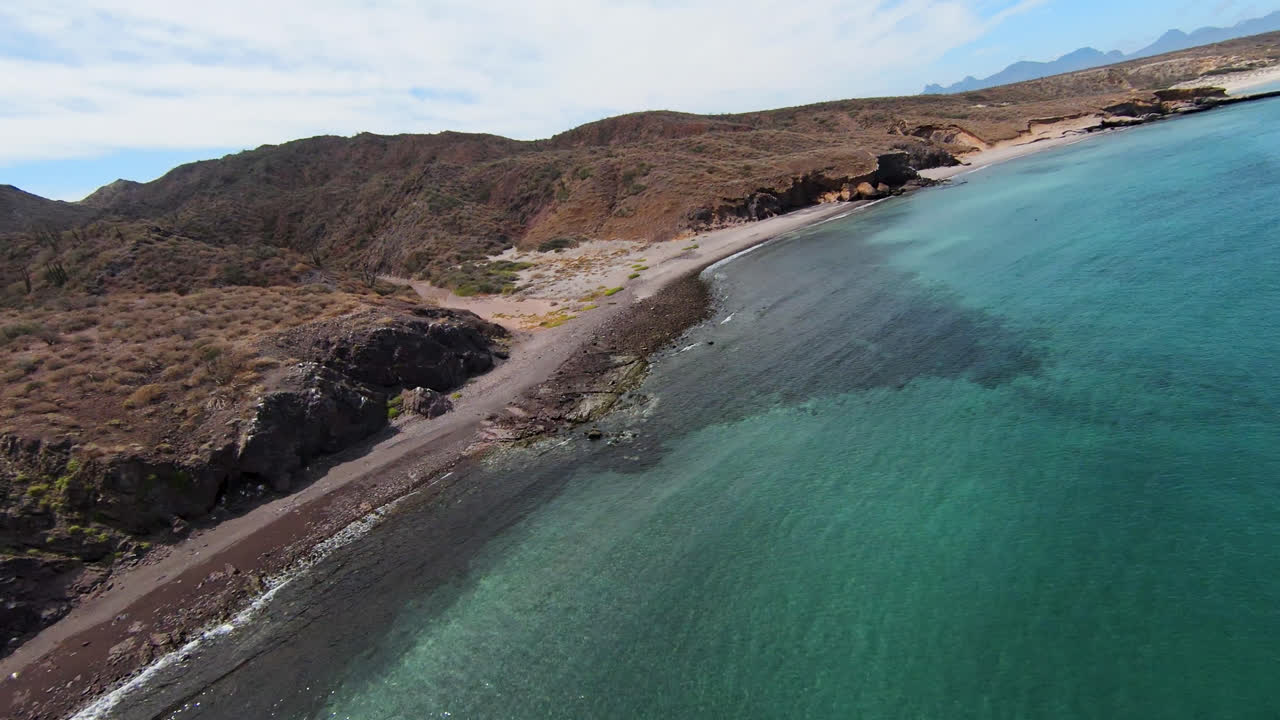 FPV drone shot of Baja California desert landscape surrounded by turquoise seawater