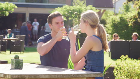 couple enjoying outdoor summer drink at pub