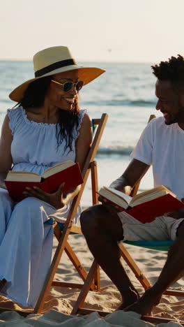 couple enjoying books on the beach
