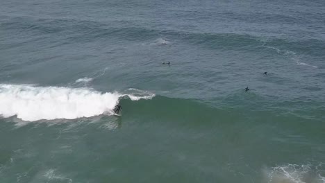 aerial view of ocean wave with surfer riding