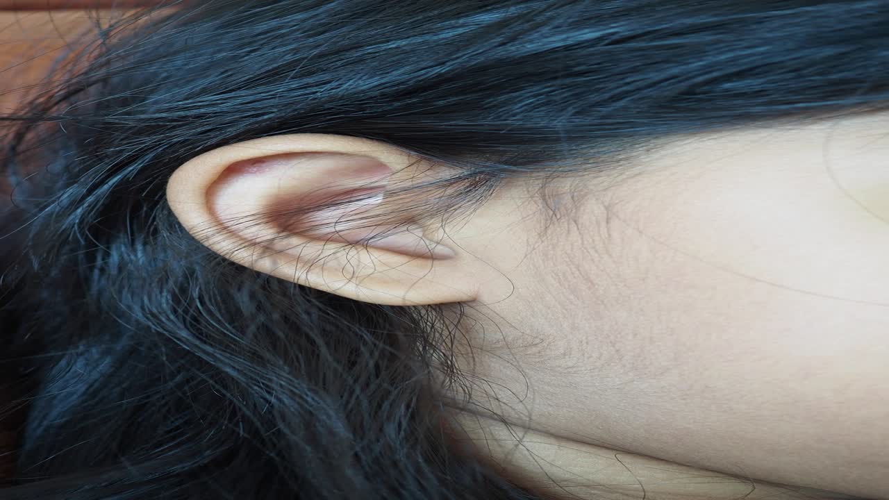 primer plano de la oreja y el cabello de una joven