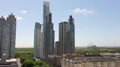 aerial parallax shot of puerto madero skyscrapers and la plata river on background