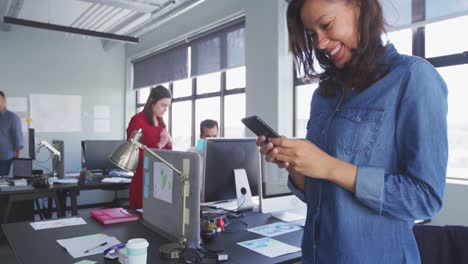 businesswoman using smartphone in modern office