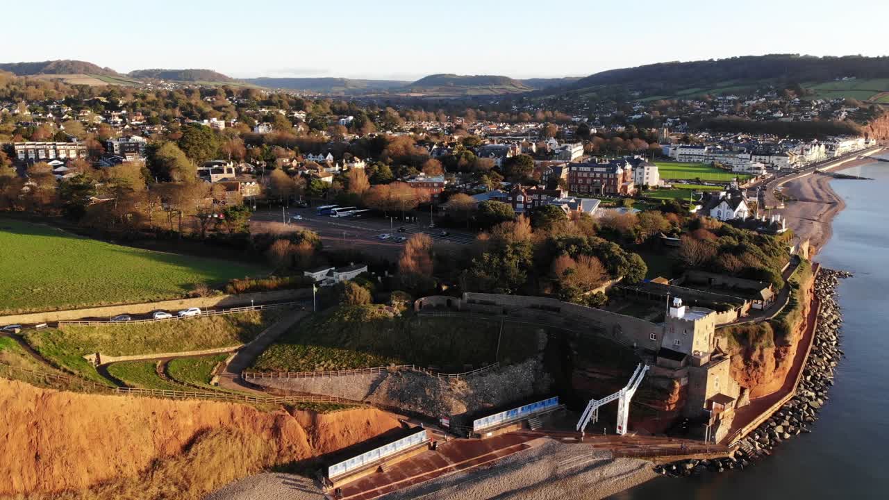 Aerial tilt reveal shot of Jacobs Ladder and Connaught Gardens Sidmouth Devon at sunrise