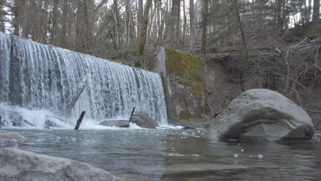 panoramic of a waterfall in a swiss forest, channeled river