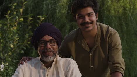 Portrait of an Indian father and son smiling outdoors