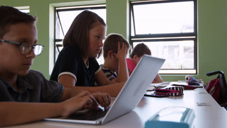 Boy-using-laptop-in-the-class