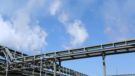 industrial pipes and structures under a blue sky
