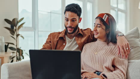 couple watching laptop together at home