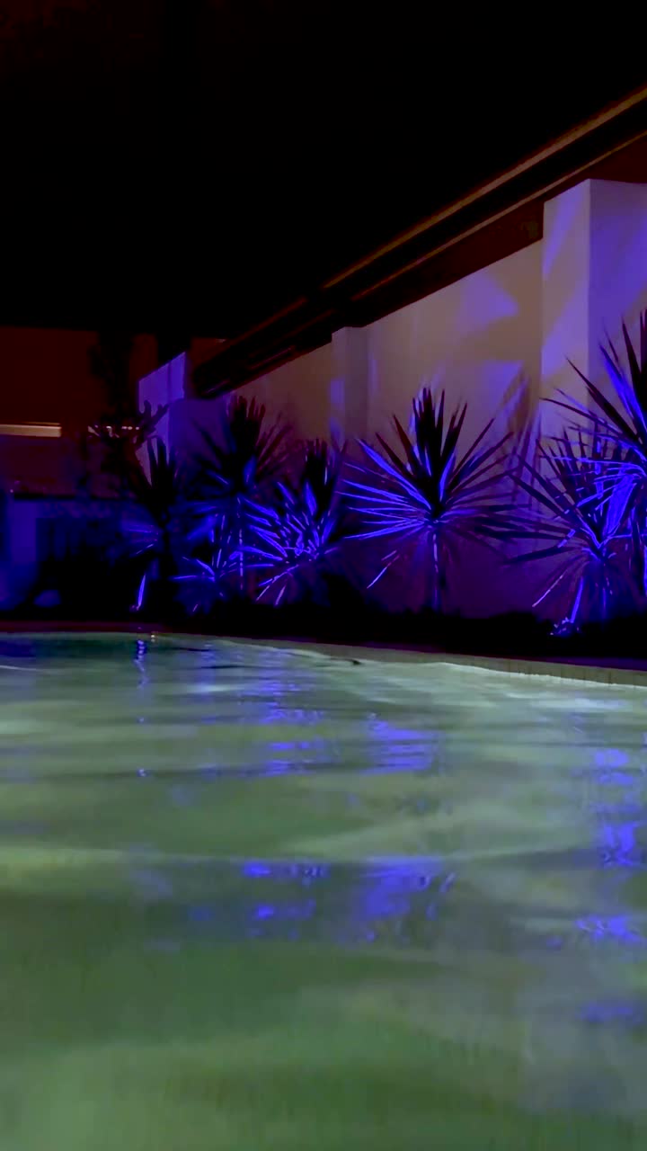 Vibrant lights reflecting on a serene pool
