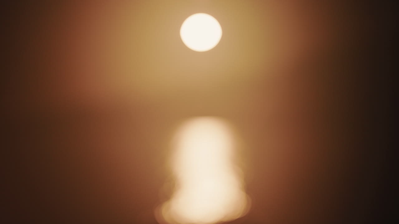 Abstract, out of focus shot of the sun and its reflection on the sea