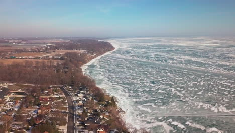 large houses along the shoreline of lake erie in kingsville, ontario during the winter season