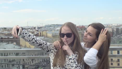 teenage girls take selfies together