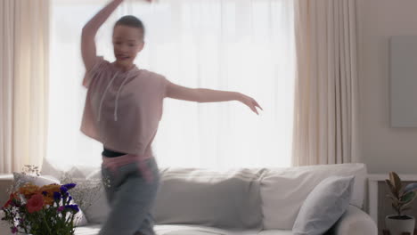 beautiful teenage girl dancing at home practicing ballet dance moves having fun rehearsing in living room