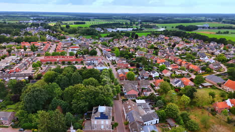 flight over the lovely houses in the cozy rural area. lush greenery of the beautiful vierlingsbeek, netherlands from drone