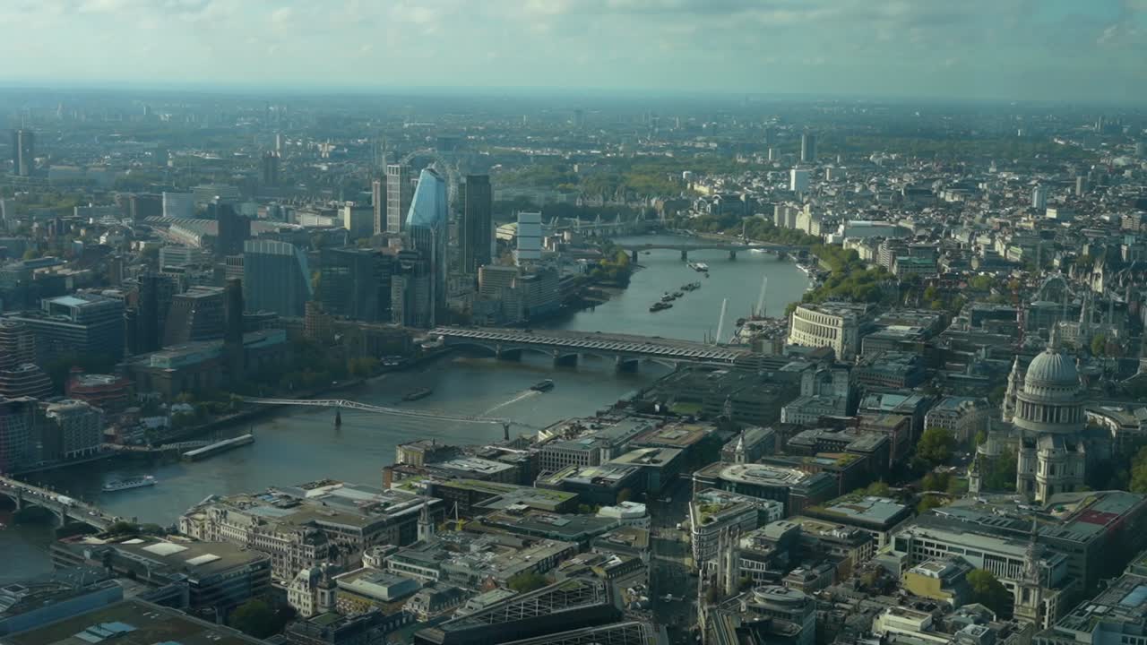 Wide panoramic view over the City of London and the Thames on a dark day, UK