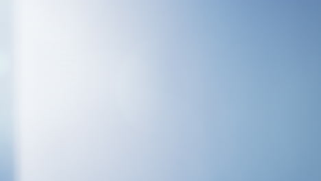 soft blue lens flare with a gentle light gradient across a clear black background. ideal for overlays, transitions, visual effects, or adding atmosphere to creative projects