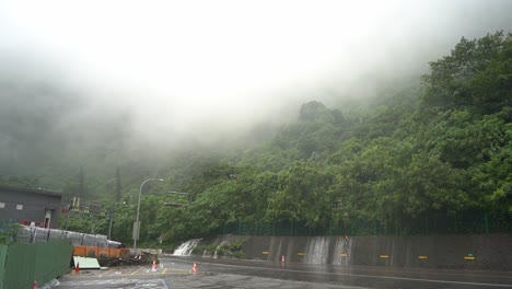 tilt up shot capturing the dangerous weather condition with heavy rainfall and fog caused hazardous driving visibility at hsuehshan tunnel at hualien city, taiwan