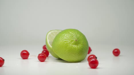 red cherry on the turntable around in the sliced lemon - close up shot