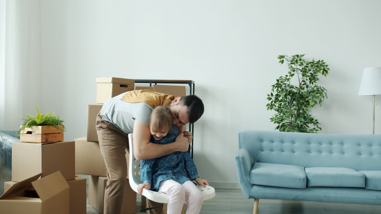 Father and Daughter playing in new home during moving process
