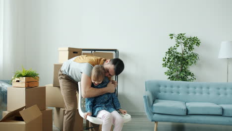 father and daughter playing in new home during moving process