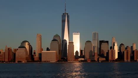 new york city skyline with one world trade center at sunset
