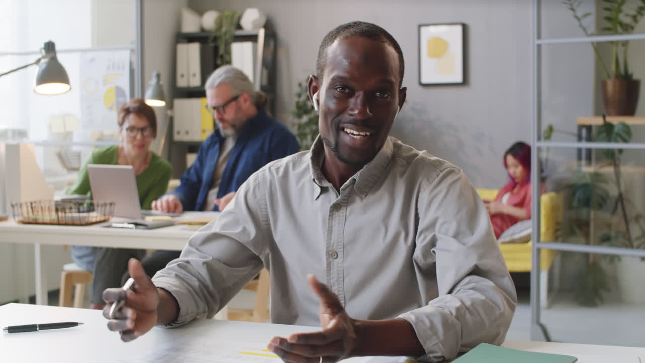 African American Man Explaining Business Document on Camera