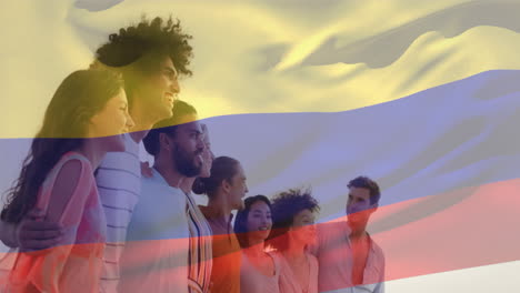 animación de la bandera de colombia ondeando sobre diversos amigos formando una cadena humana y mirando hacia el mar