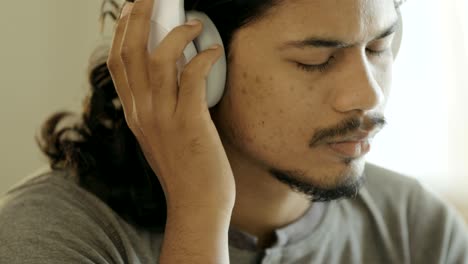 young man listening music in headphones