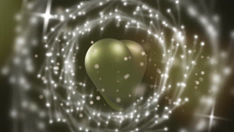 animación de puntos de luz y círculos sobre un corazón dorado sobre fondo negro.
