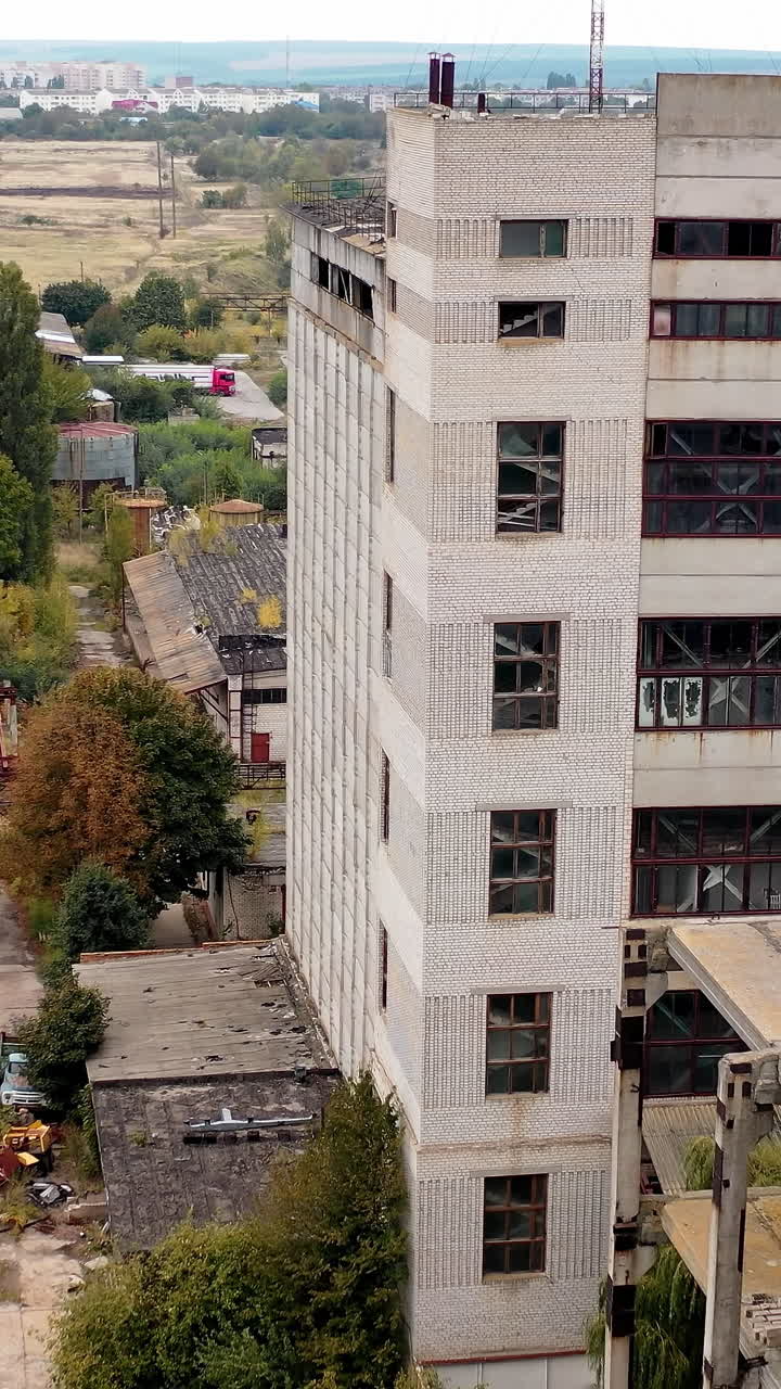 Factory destroyed empty buildings. Aerial view of destructive abandoned architecture. Vertical video