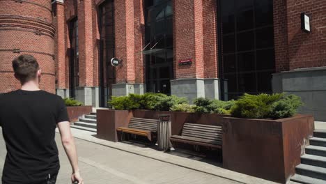 man walking through a modern urban cityscape