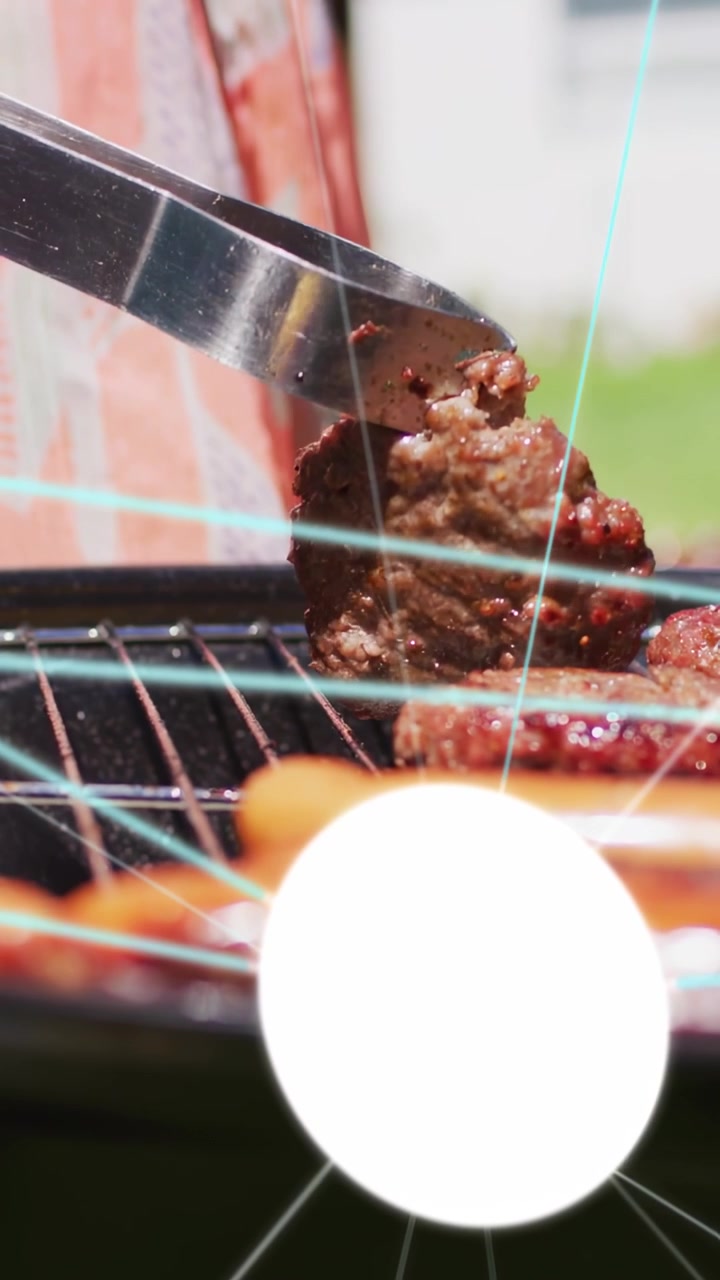 Vertical video: Woman operating grill sliding tongs from left, lifting patties and flipping for bbq