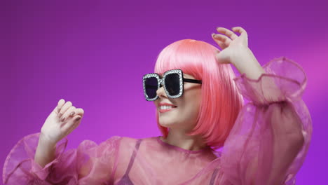 portrait of beautiful woman wearing a pink wig and fancy glasses 1