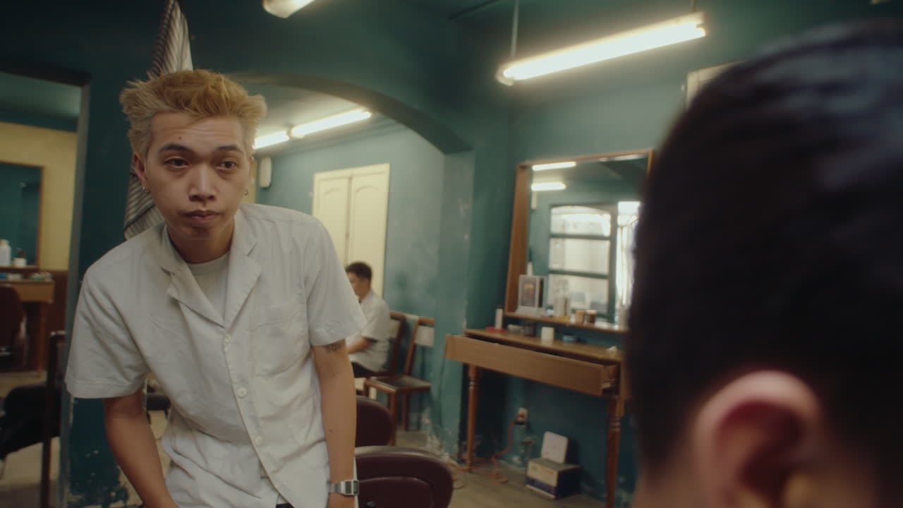 Asian Barber Checking Haircut and Using Clippers