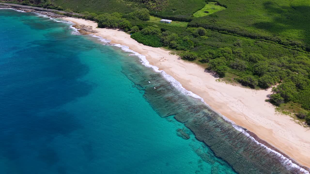 Coral reef and turquoise water along a secluded beach on Oahu, Hawaii, aerial