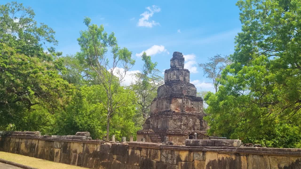 Satmahal Prasada, a rare 12th-century stepped pyramid in ancient Polonnaruwa, Sri Lanka, basks under the bright sun, showcasing its unique architectural charm
