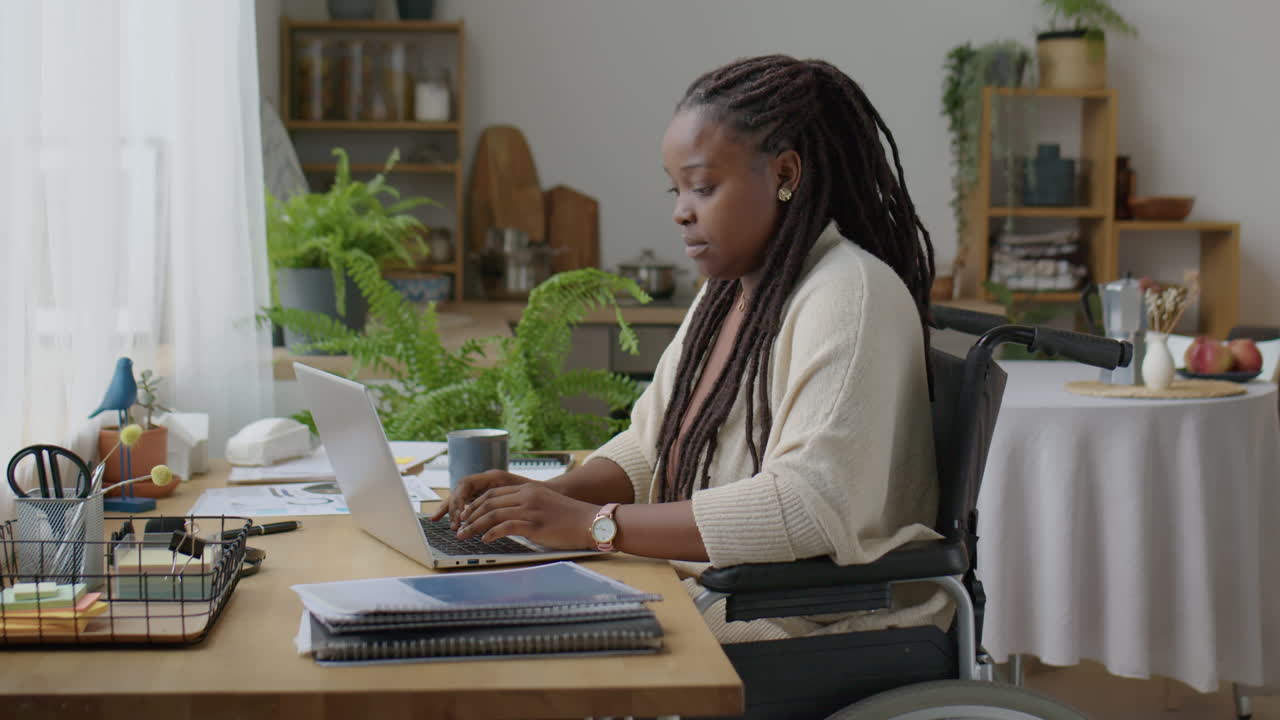 Woman in Wheelchair Working Remotely from Home