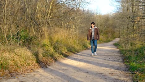 singly man walking in forest