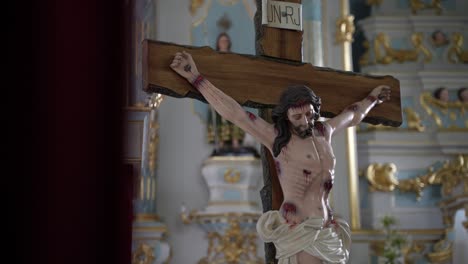 Detailed-crucifixion-statue-with-ornate-church-background